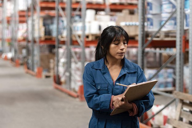 woman-worker-taking-notes-warehouse pallet racking singapore